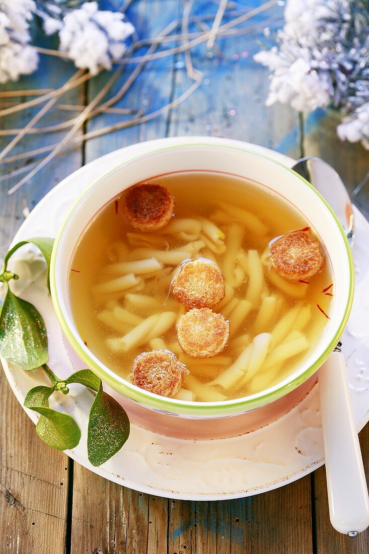 Clear broth with noodles and croutons