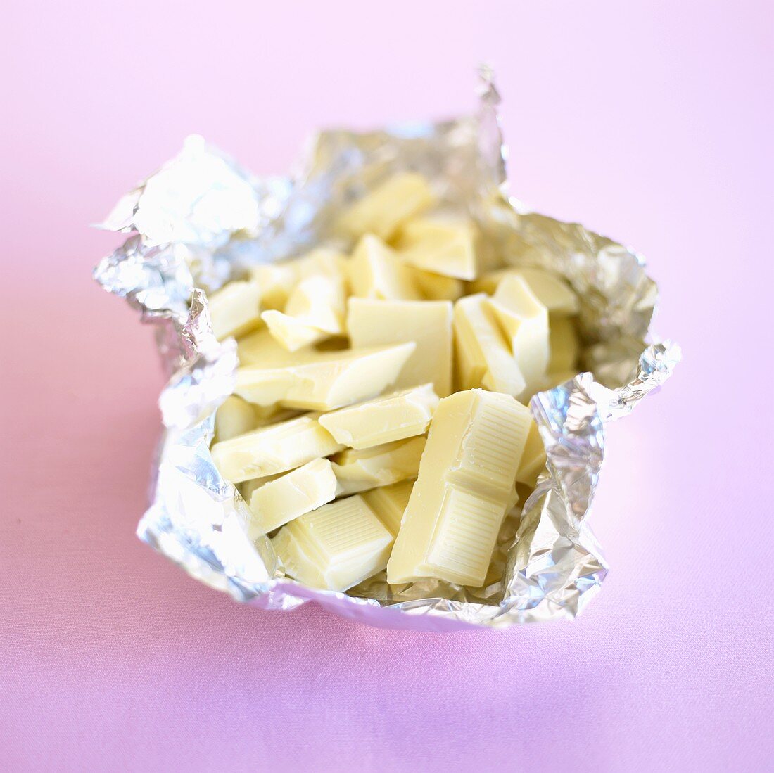 Broken white chocolate in aluminium foil