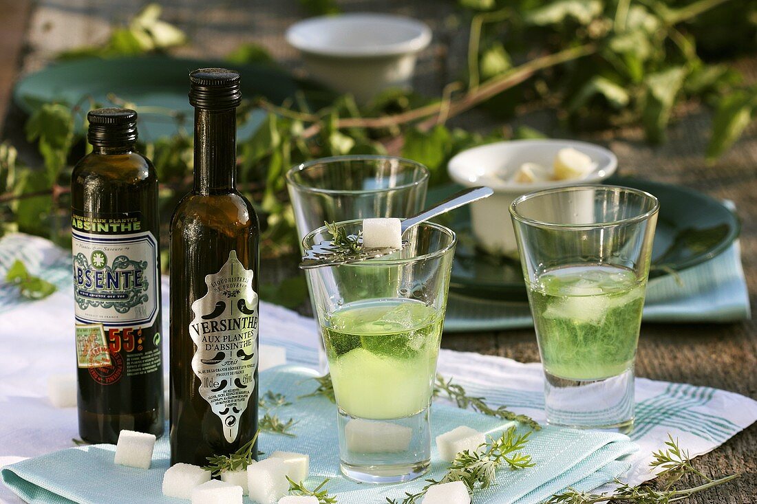 Three glasses of absinthe with iced water