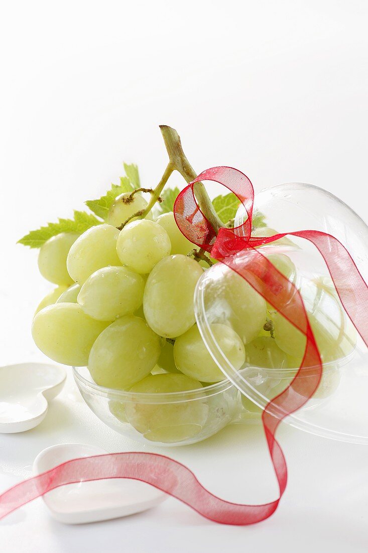Green grapes in heart-shaped plastic container