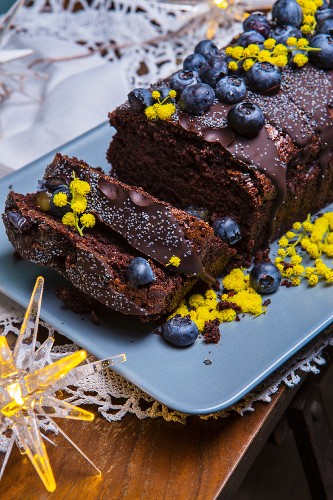 Beetroot and chocolate cake with blueberries and edible mimosa