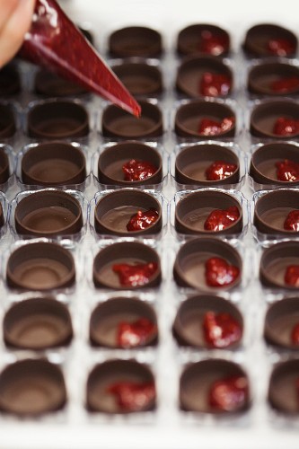 Filling Chocolate Molds with Raspberry Filling