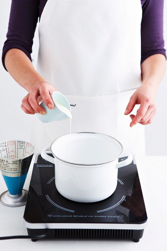 Milk and cream being brought to the boil to make chocolate mousse