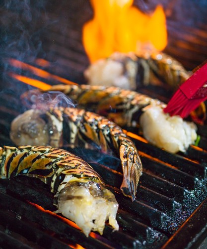 Halved lobster tails on a barbecue