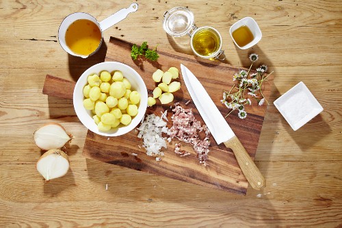 Ingredients for making warm potato salad with daisies