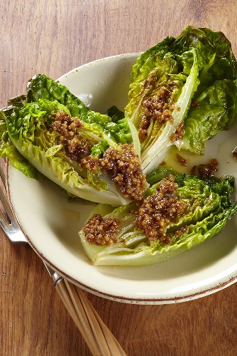 Cos lettuces halved and fried served with a dressing made from coarse mustard