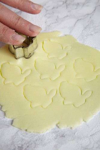 Easter bunnies being cut out of fondant icing