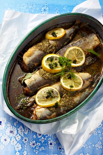 Oven-roasted herring with lemon and herb butter