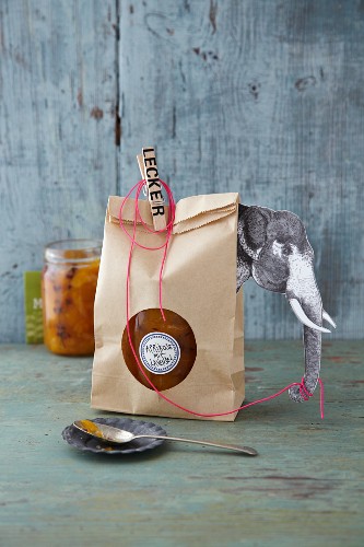 Jam in a paper bag decorated with an elephant as a gift