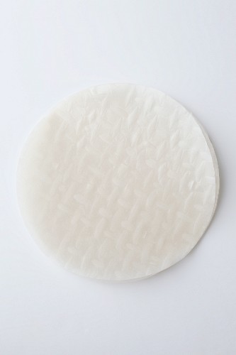 A round sheet of rice paper on a white … – License Images – 11374666 ❘  StockFood