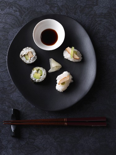 Vegan nigiri and maki sushi with tofu, radishes and cucumber