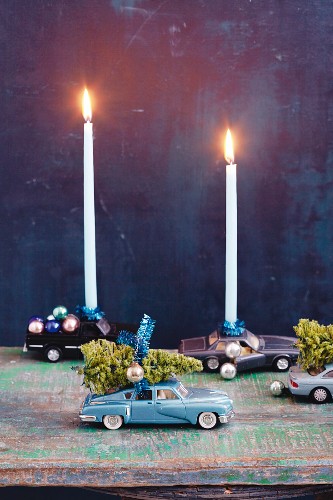 Toy cars as candle holders for Christmas decorations