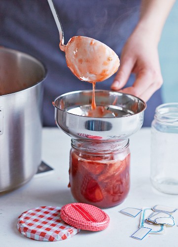 Homemade jam being transferred to jars