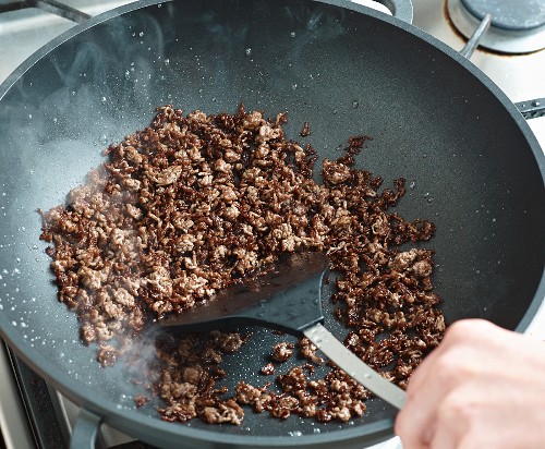 Beef being fried in a wok