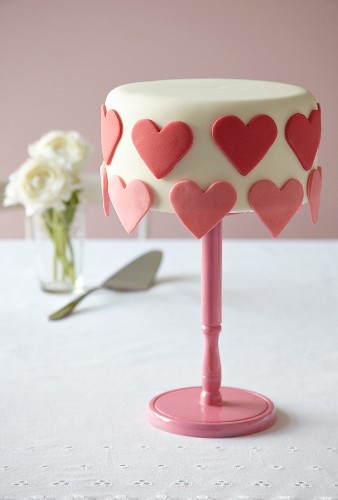 A cake decorated with overhanging hearts for Valentine's Day (Madeira cake)