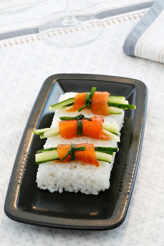 Salmon rolls with cucumber on a bed of rice