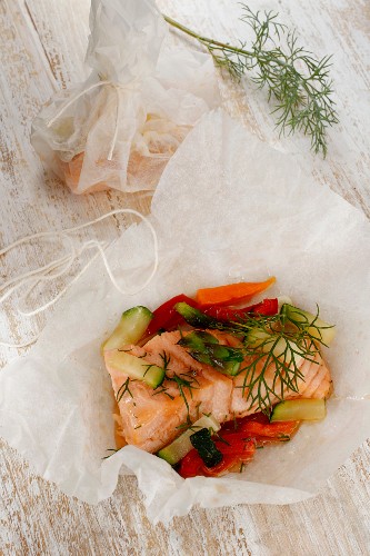 Salmon with colourful vegetables baked in parchment paper