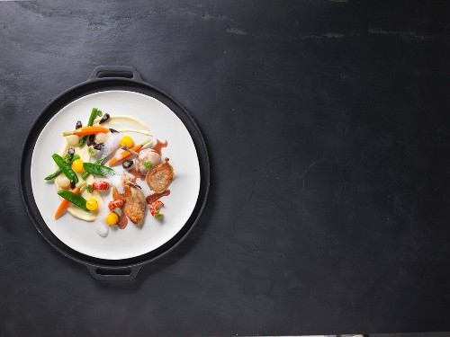 Sous-vide spring chicken with crayfish tails and colourful vegetables