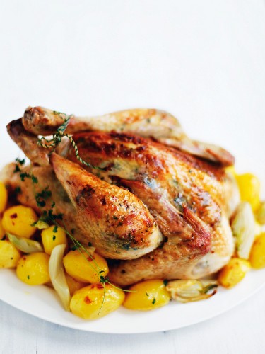 Roast chicken with spiced butter and potatoes