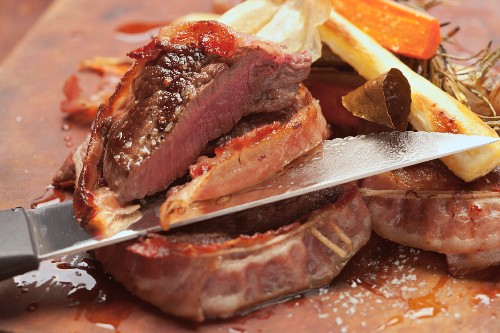 Slicing bacon-wrapped beef fillet