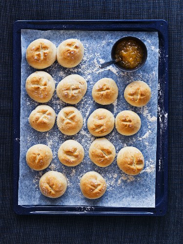 Scones with jam on a baking tray