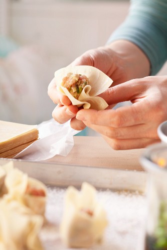 Meat-filled won tons being prepared