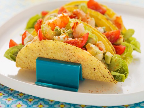 Taco shells filled with avocado and prawns
