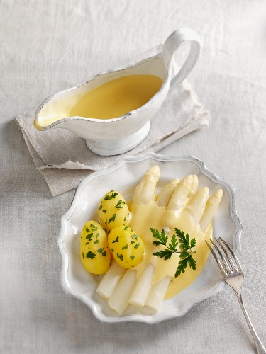 White asparagus soup with sauce hollandaise and potatoes