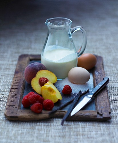 An arrangement of milk, eggs, fruit and vanilla pods