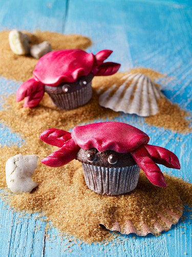 Chocolate muffins shaped like crabs on brown sugar