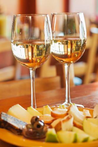Two Glasses of White Wine with Fruit and Cheese