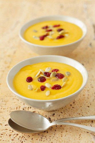 Cream of pumpkin soup with cranberries and pumpkin seeds