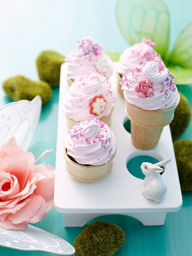 Chocolate cupcakes in ice cream cones with pink buttercream topping