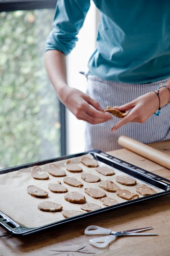 Almond biscuits being placed on a baking tray to be baked