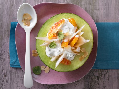 Melon filled with yoghurt, pear and blood oranges