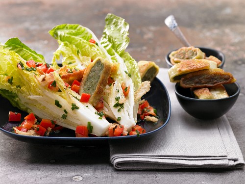 Pan-fried Maultaschen (Swabian ravioli) with cos lettuce and red pepper