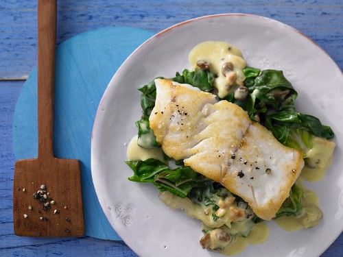 Pan-fried coalfish on a bed of chard curry