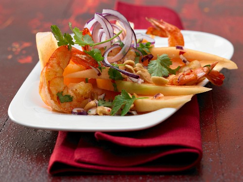 A prawn salad with melon wedges