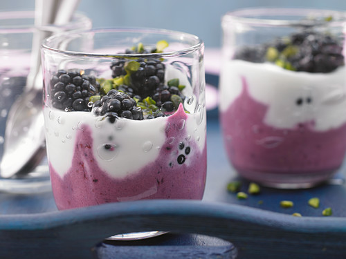 Layered blackberry yoghurt with pistachios