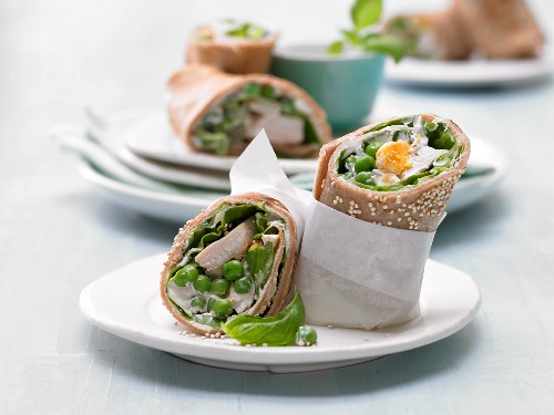 Pancake wraps with chicken, peas, egg, lettuce and sesame seeds