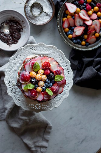 A vanilla cake decorated with fresh fruit