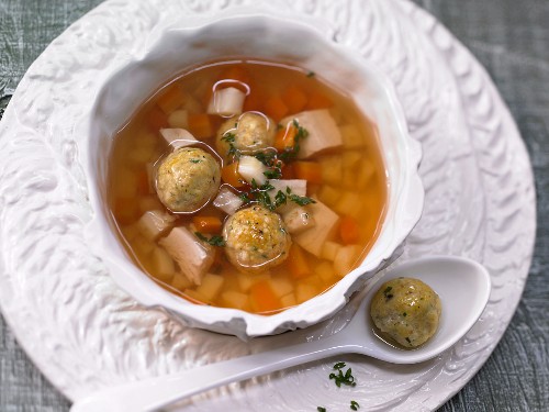 Vegetable soup with matzah balls and chicken breast