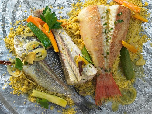 Three varieties of fish with vegetables and saffron couscous