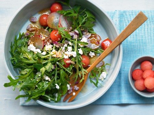 A fruity arugula salad with watermelon, fresh cheese and radishes