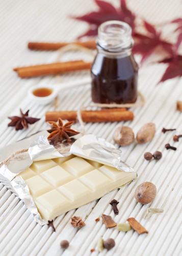 An arrangement of white chocolate, spices and syrup