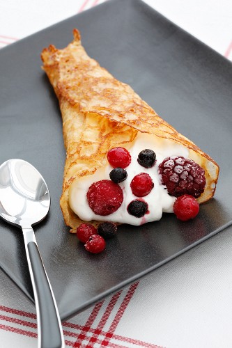Crepe with whipped cream and wild berries