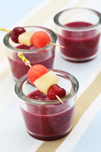 A pineapple, cherry and watermelon smoothie with fruit pies