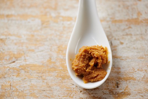 Miso paste on a ceramic spoon ready to add to a recipe