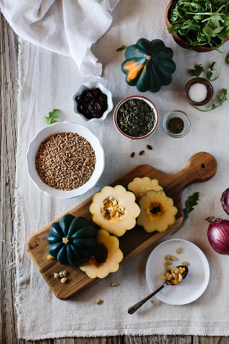 Ingredients for Roasted Acorn Squash Salad with Farro are displayed on a farm style board