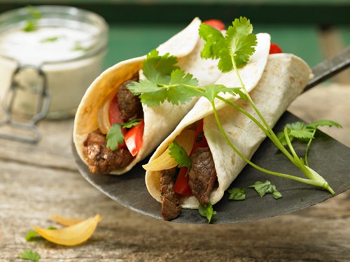 Tortilla wrap with beef and strips of red pepper
